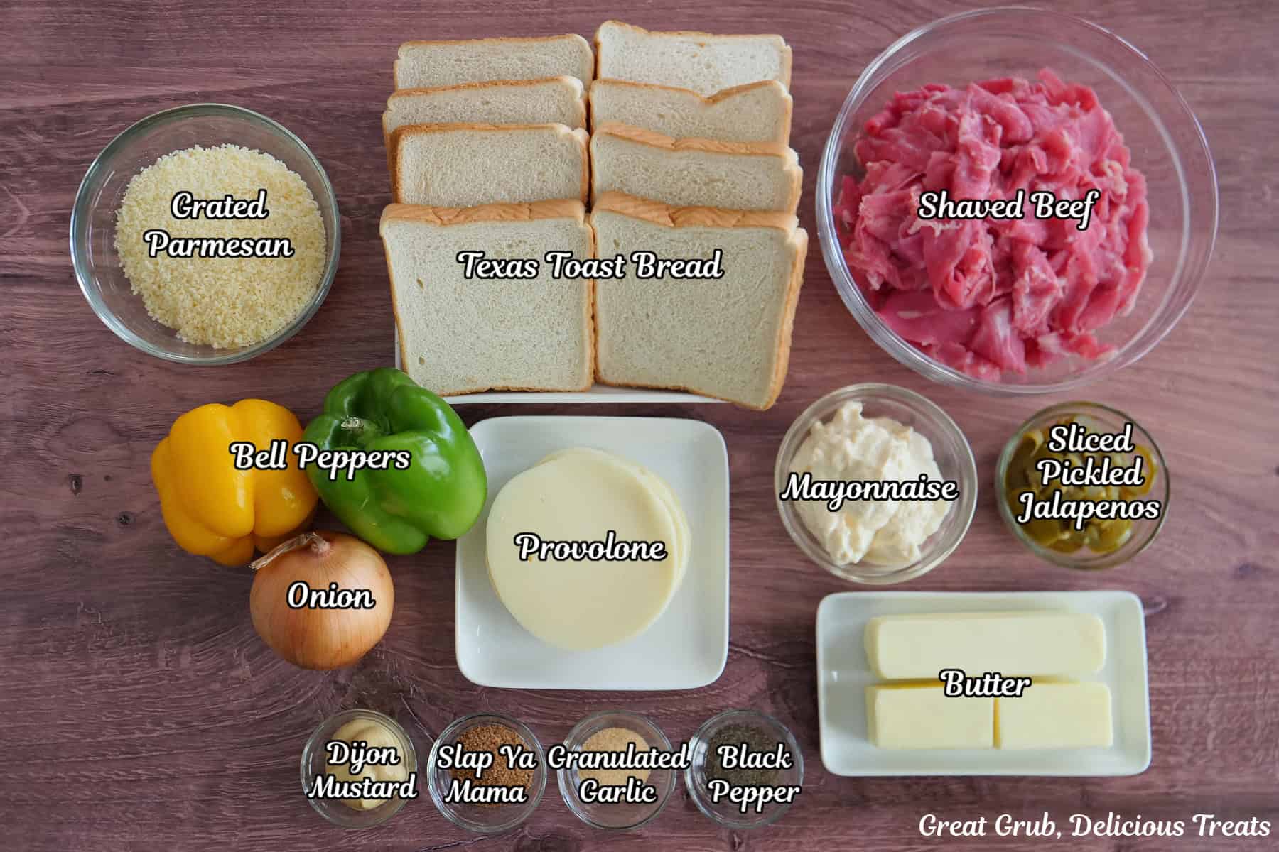A wood surface with all the ingredients placed on it to make cheesesteak grilled cheese sandwiches.