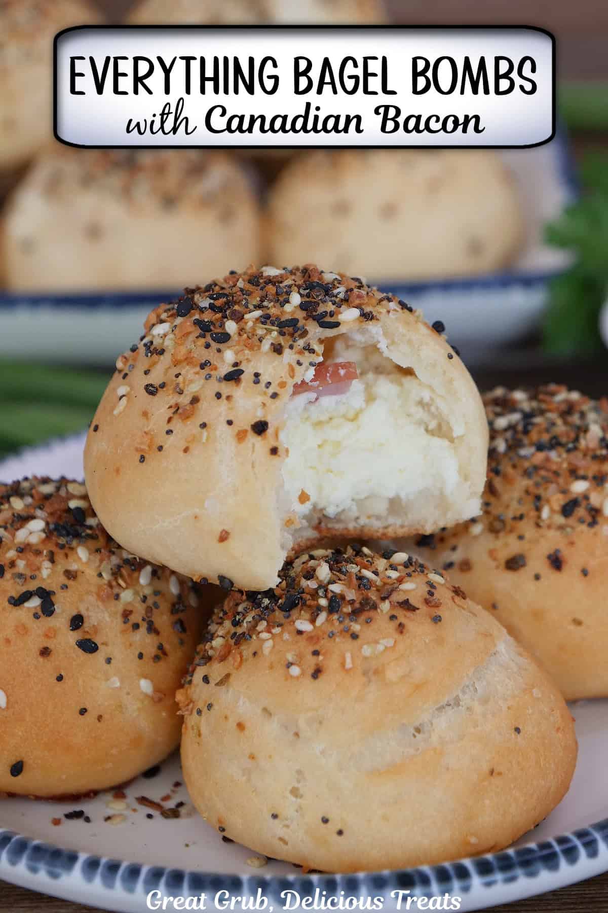 A round white plate with blue trim with five everything bagel bombs on it with a title overlay at the top.