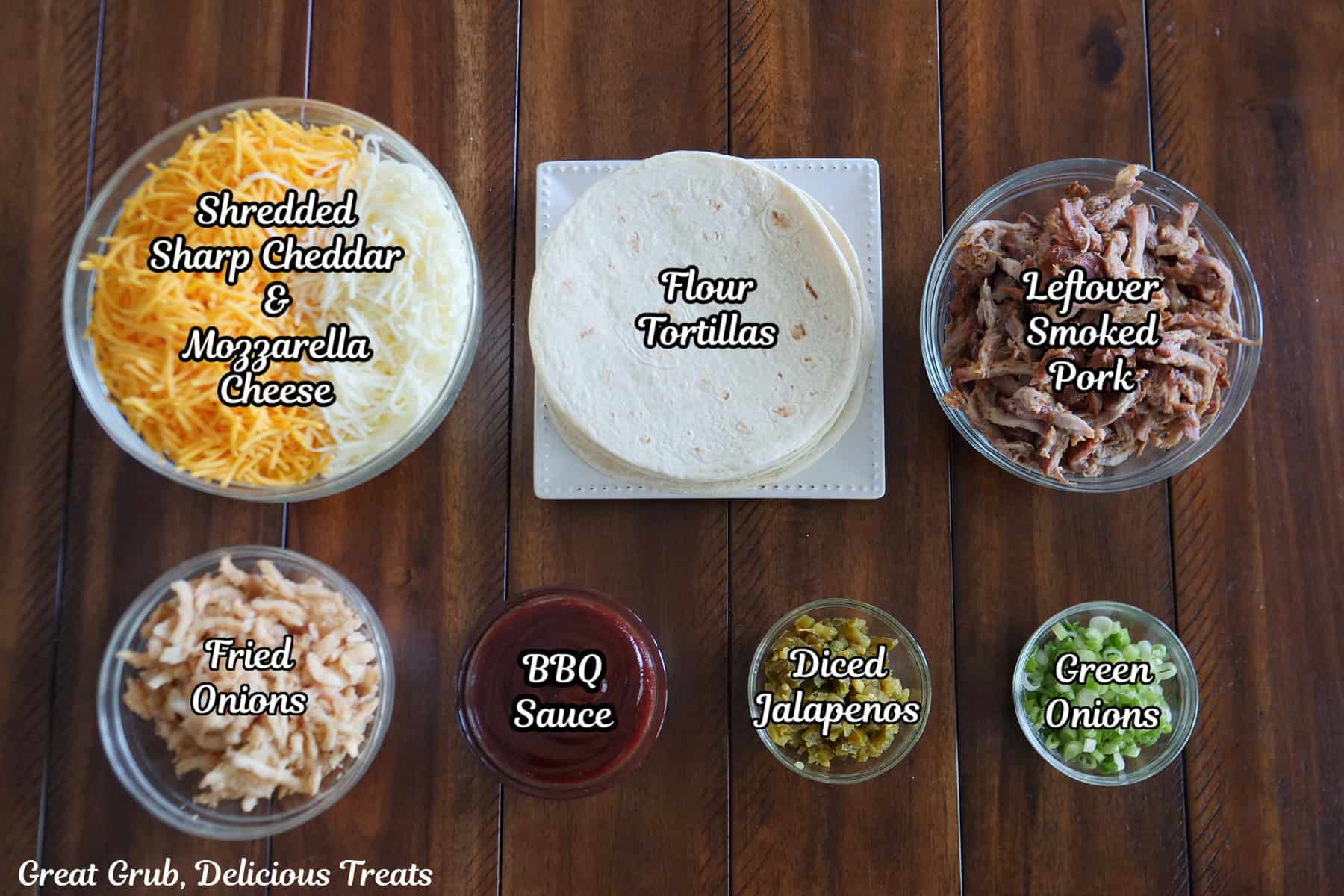 A wood surface with all the ingredients needed to make leftover pulled pork quesadillas placed on it.
