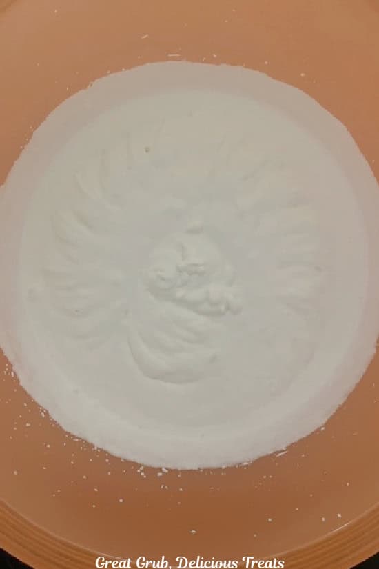 A mixing bowl with homemade whipped cream in it.