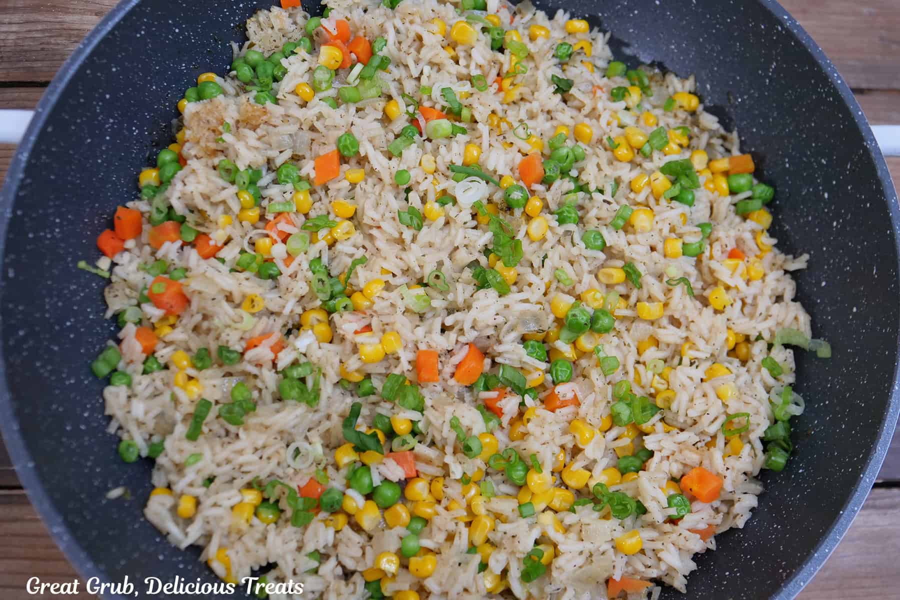 A pan with garlic vegetable rice in it after being cooked.