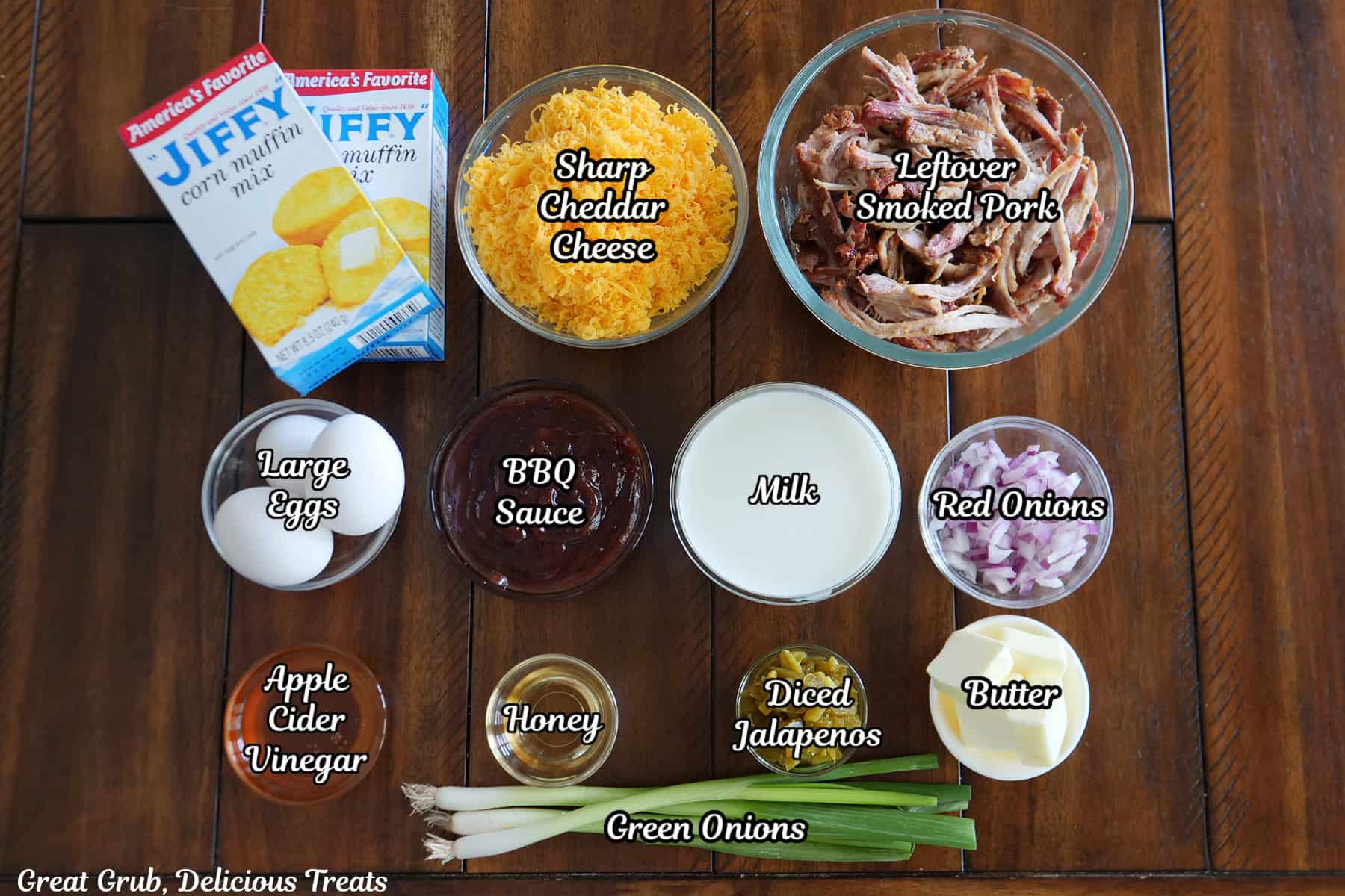 A wood surface with all the ingredients on it to make pulled pork cornbread waffles.