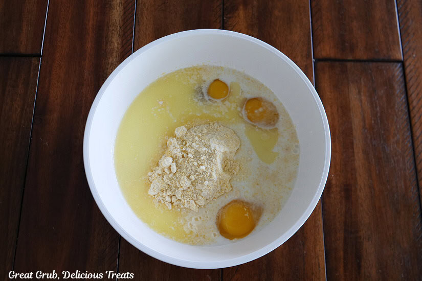 A white bowl with the waffle batter ingredients in it before being mixed together.