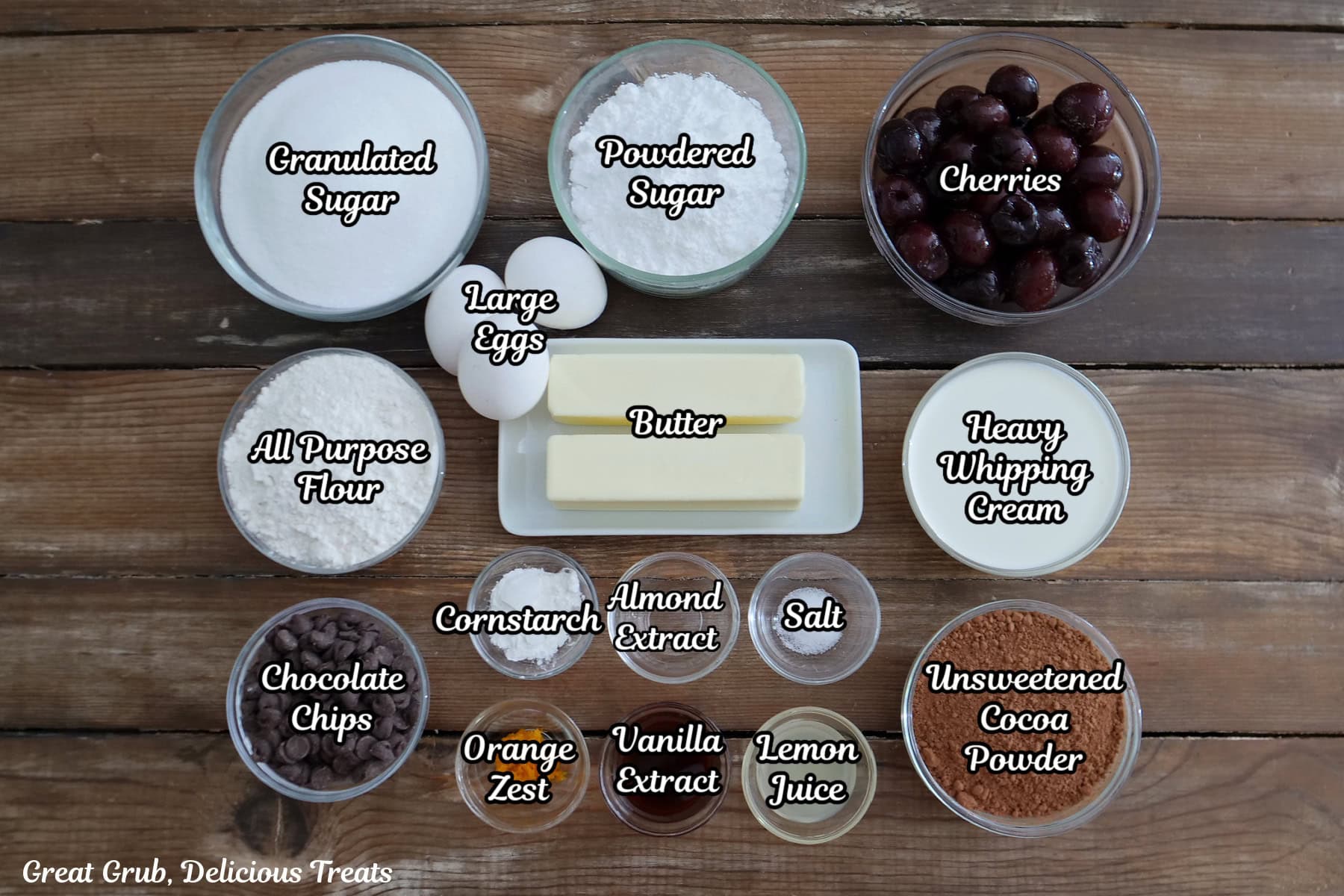 A wood surface with all the ingredients on it to make black forest brownies.