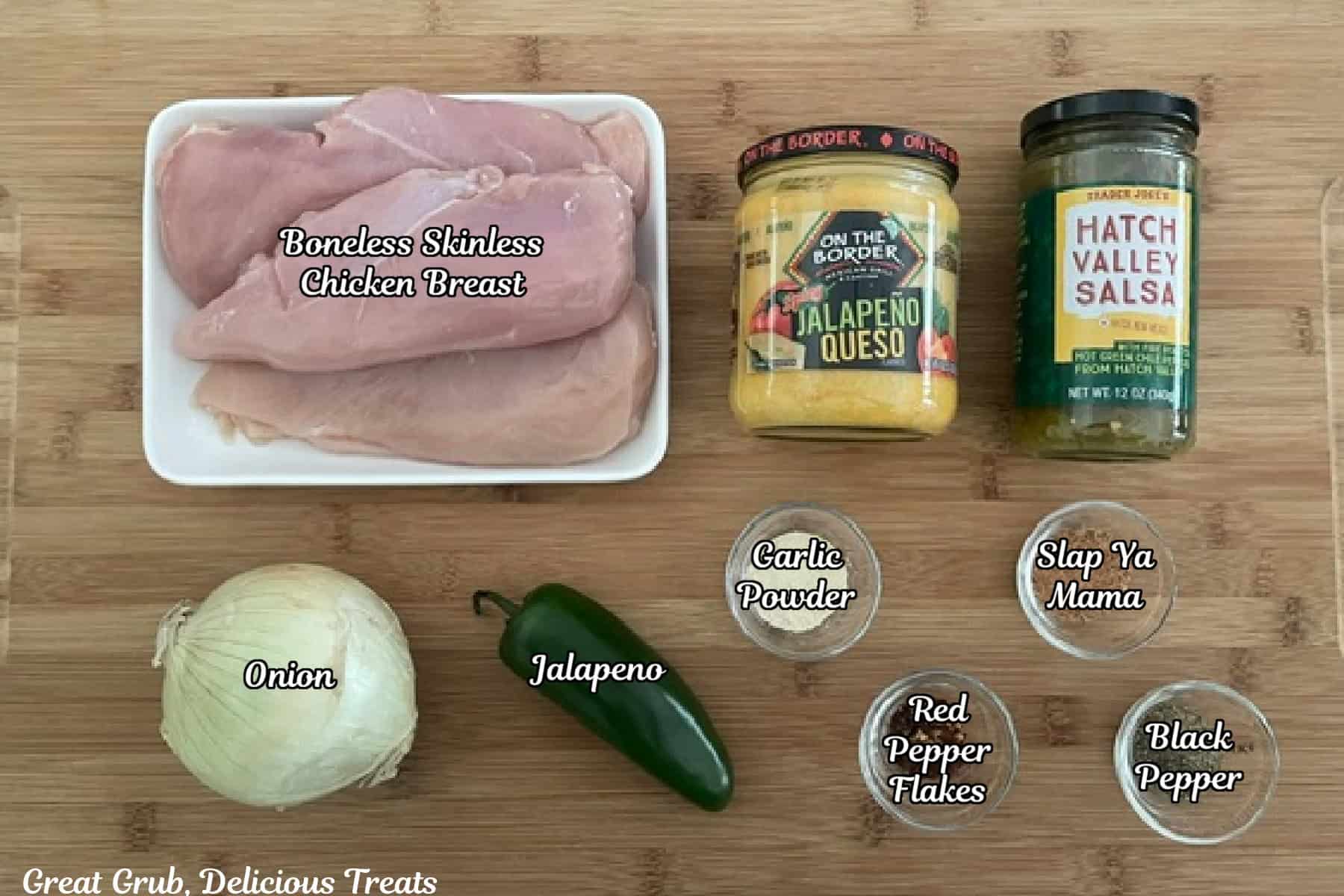 A wood surface with all the ingredients placed on it to make crock pot spicy queso chicken.