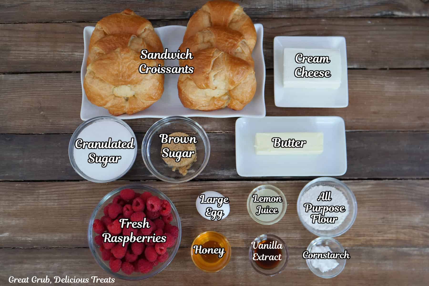 A wood surface with all the ingredients place on it to make raspberry cream cheese croissants.