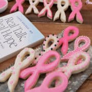 A wood surface with frosted ribbon sugar cookies on a silver tray and Dr. Loren Rourke's book, "Real Talk, Real Hope" in the background.