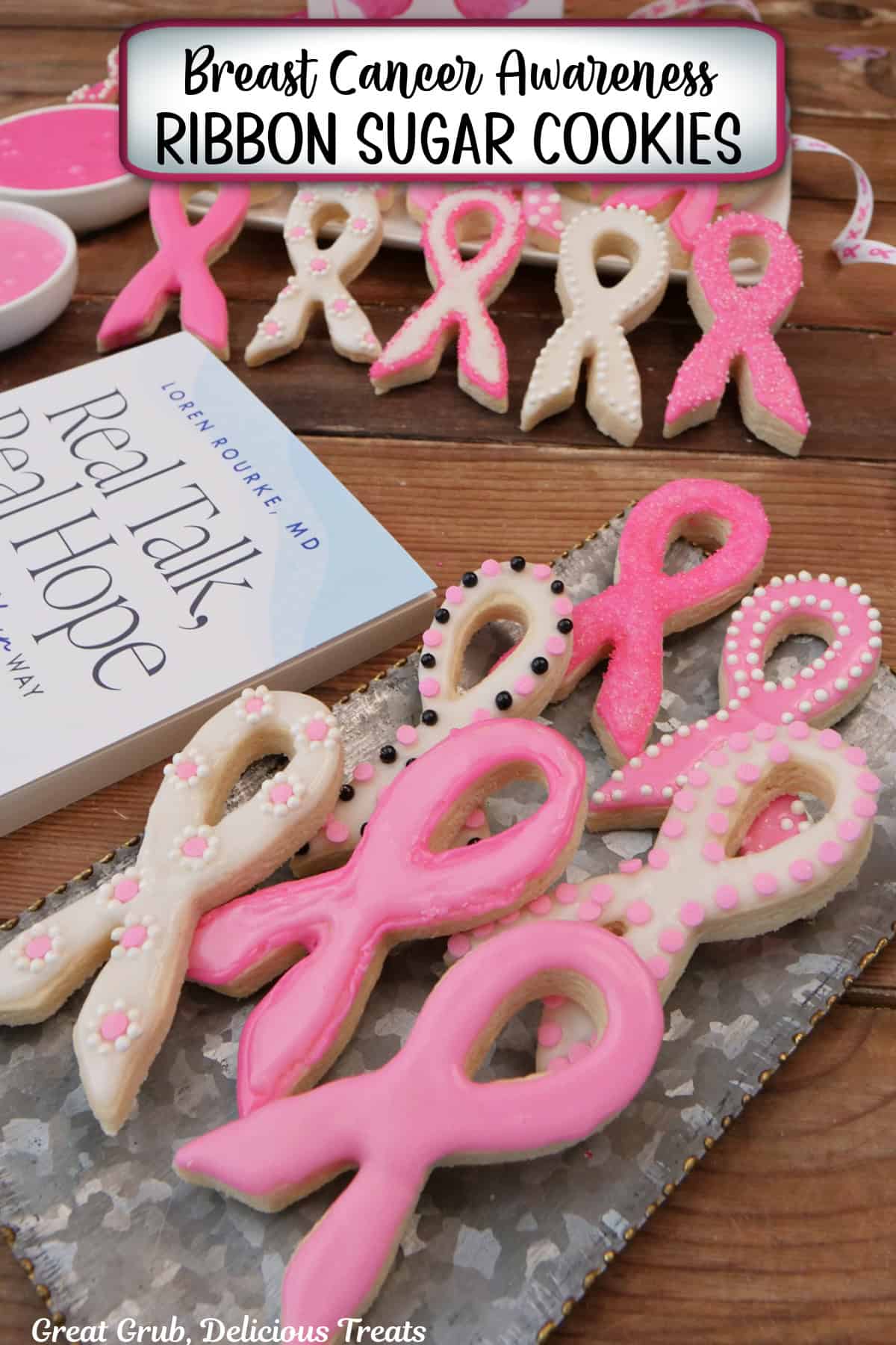 A wood surface with frosted ribbon sugar cookies on a silver tray and Dr. Loren Rourke's book, "Real Talk, Real Hope" in the background.
