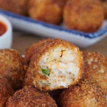 A white plate with a stack of deep fried chicken and rice bites with a bite taken out of the one on top, and a title overlay at the top.