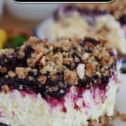 A white plate with a serving of lemon blueberry pretzel salad on it with a bite taken out of it, and a title overlay at the top.