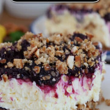 A white plate with a serving of lemon blueberry pretzel salad on it with a bite taken out of it, and a title overlay at the top.