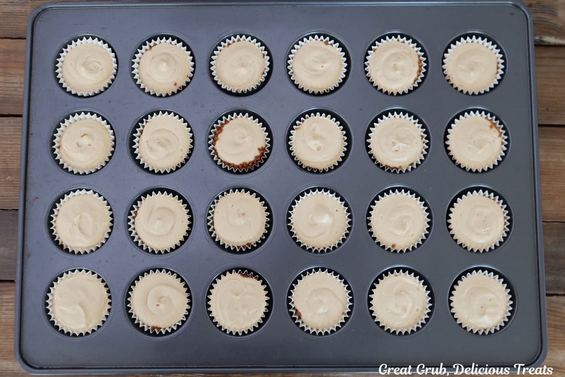 A mini 24-count muffin tin with peanut butter cheesecake added to the cookie crusts.