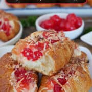 A white plate with three mini croissants filled with a pineapple cherry cheesecake filling, and a title overlay at the top.