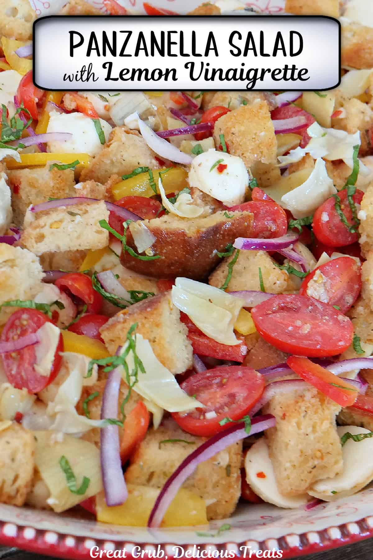 A red and white bowl filled with panzanella salad with a title overlay at the top.