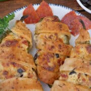 A round white plate with blue trim with three pepperoni pizza jalapeno poppers on it with a title overlay at the top.