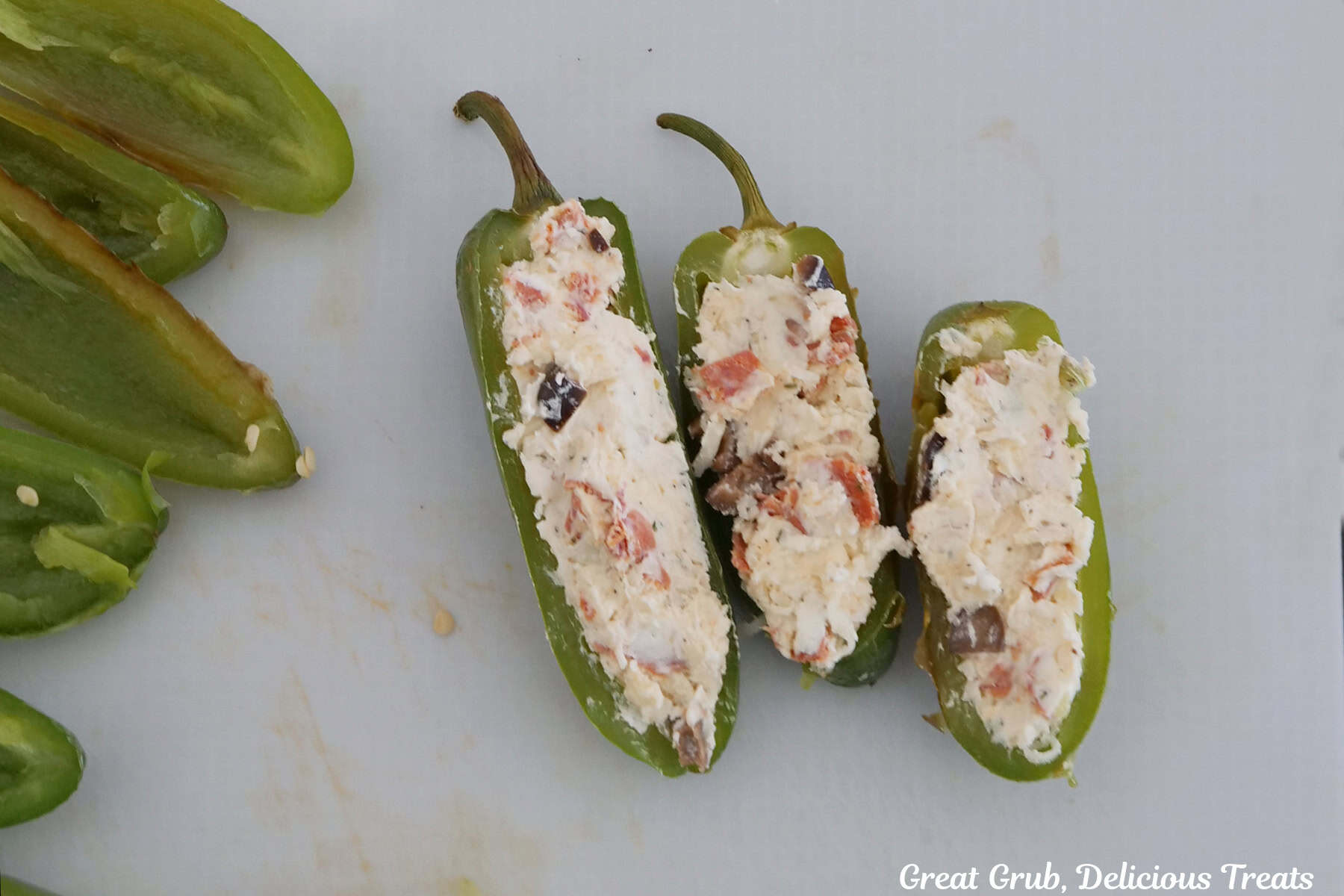 Three jalapeno halves filled with the pepperoni pizza cream cheese filling.