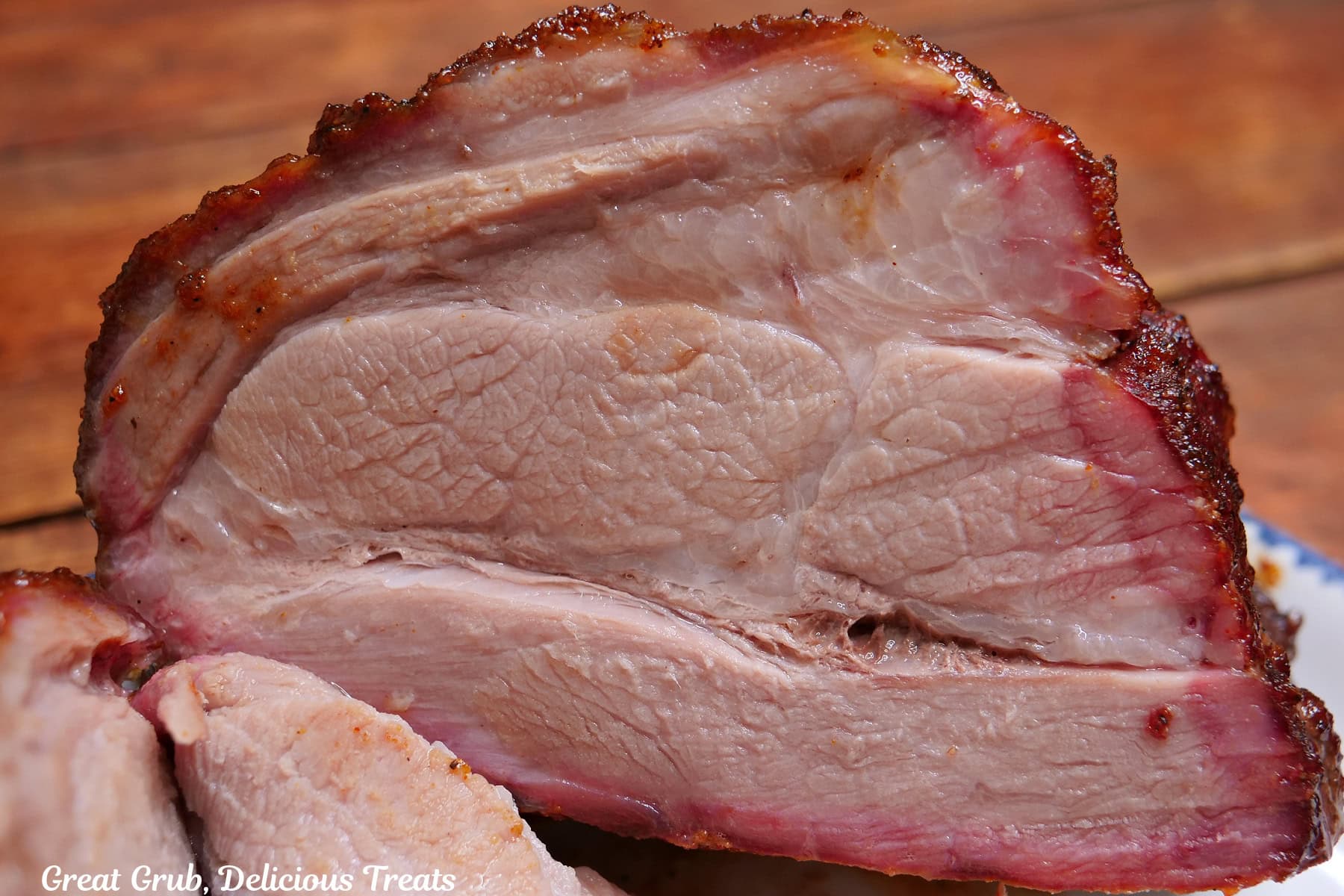 A smoked pork roast sliced to show the nice smoke ring around the edges.