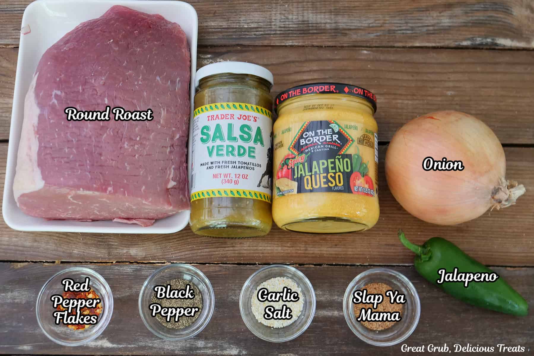A wood surface with all the crockpot roast beef ingredients placed on it.