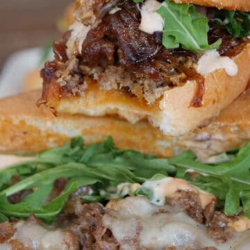 A steak sandwich stacked on top of another steak sandwich, and a title overlay at the bottom