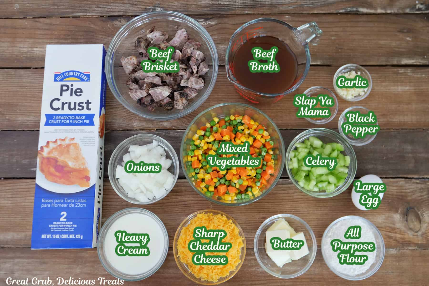 A wood surface with all the ingredients placed on it to make a beef brisket pot pie.