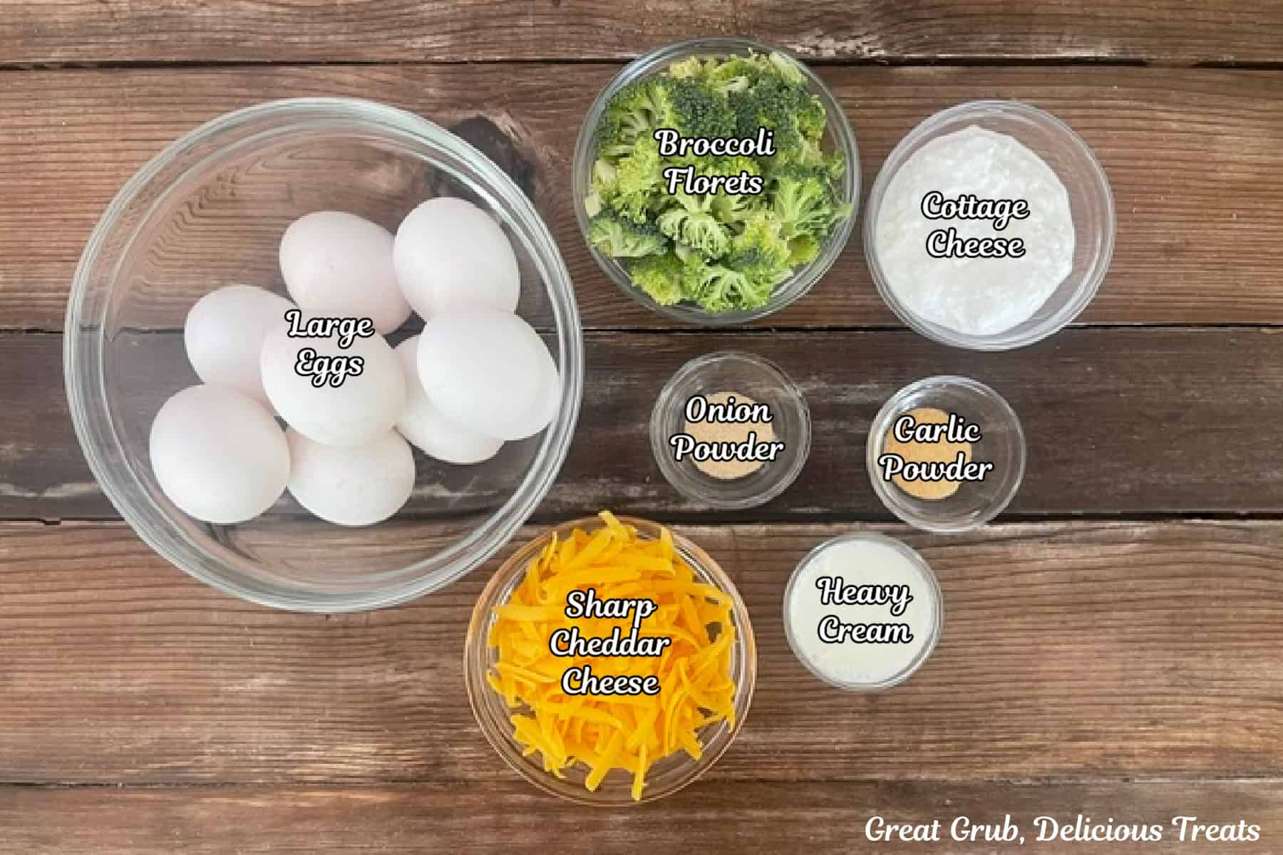 A rustic wood surface with all the ingredients placed on it to make broccoli cheddar egg bites.