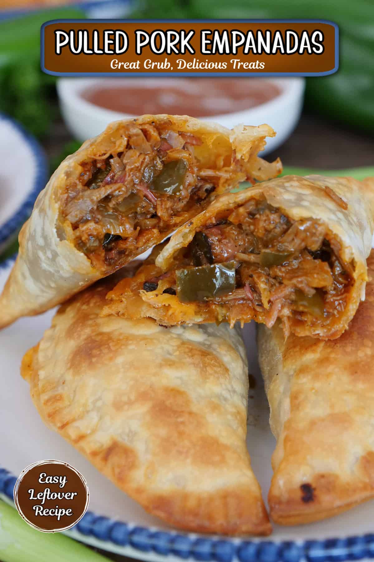 Three pulled pork empanadas on a white plate with blue trim with one cut in half showing the inside ingredients, and a title overlay at the top.