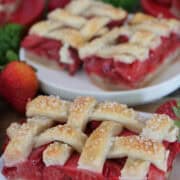 Strawberry pie bars on white plates with lattice pie topping, and a title overlay at the top.