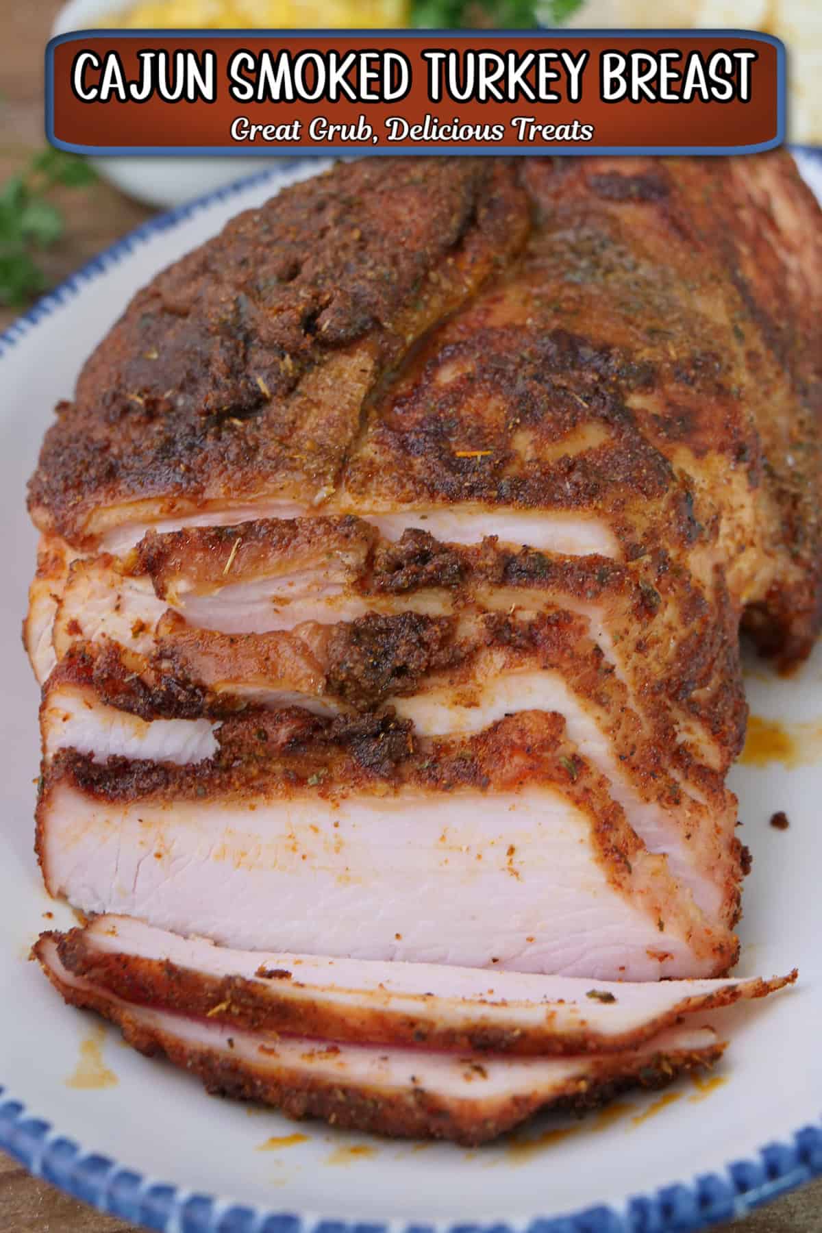 A blue trimmed white plate with a smoked Cajun turkey breast on it with a few slices cut, and a title overlay at the top.