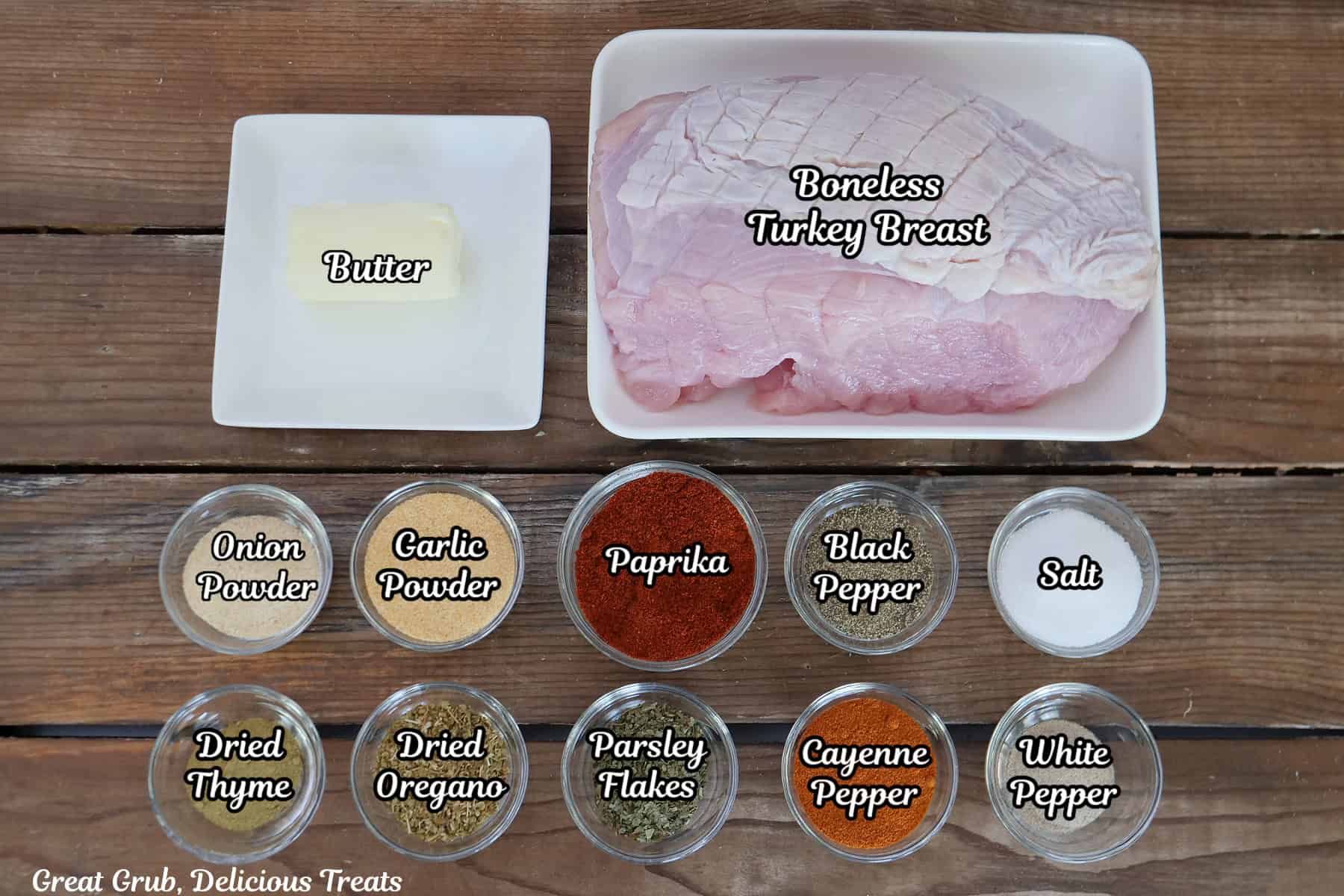 A wood surface with all the ingredients placed on it to make Cajun smoked turkey breast.