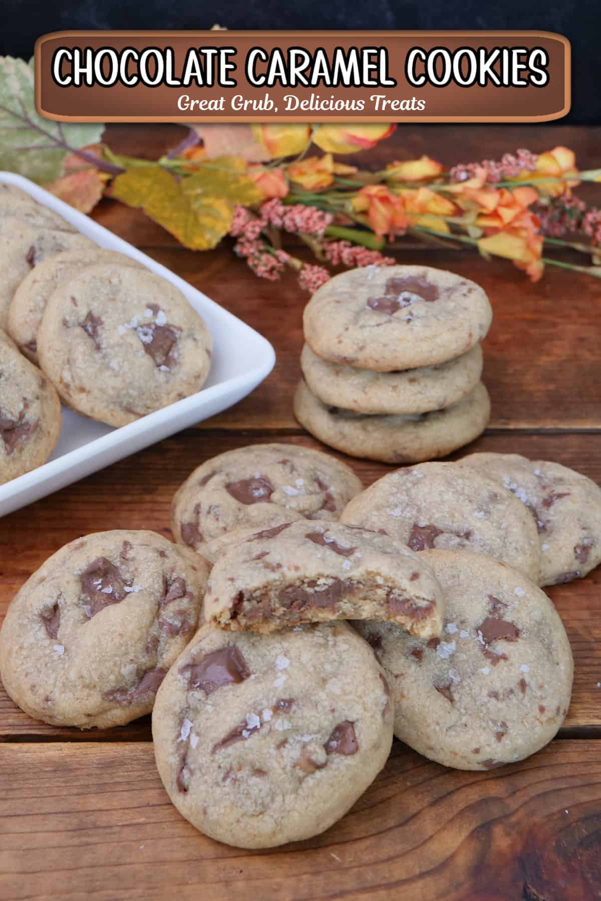 A wood surface with chocolate caramel cookies placed on it with fall foliage in the background, and a title overlay at the top.