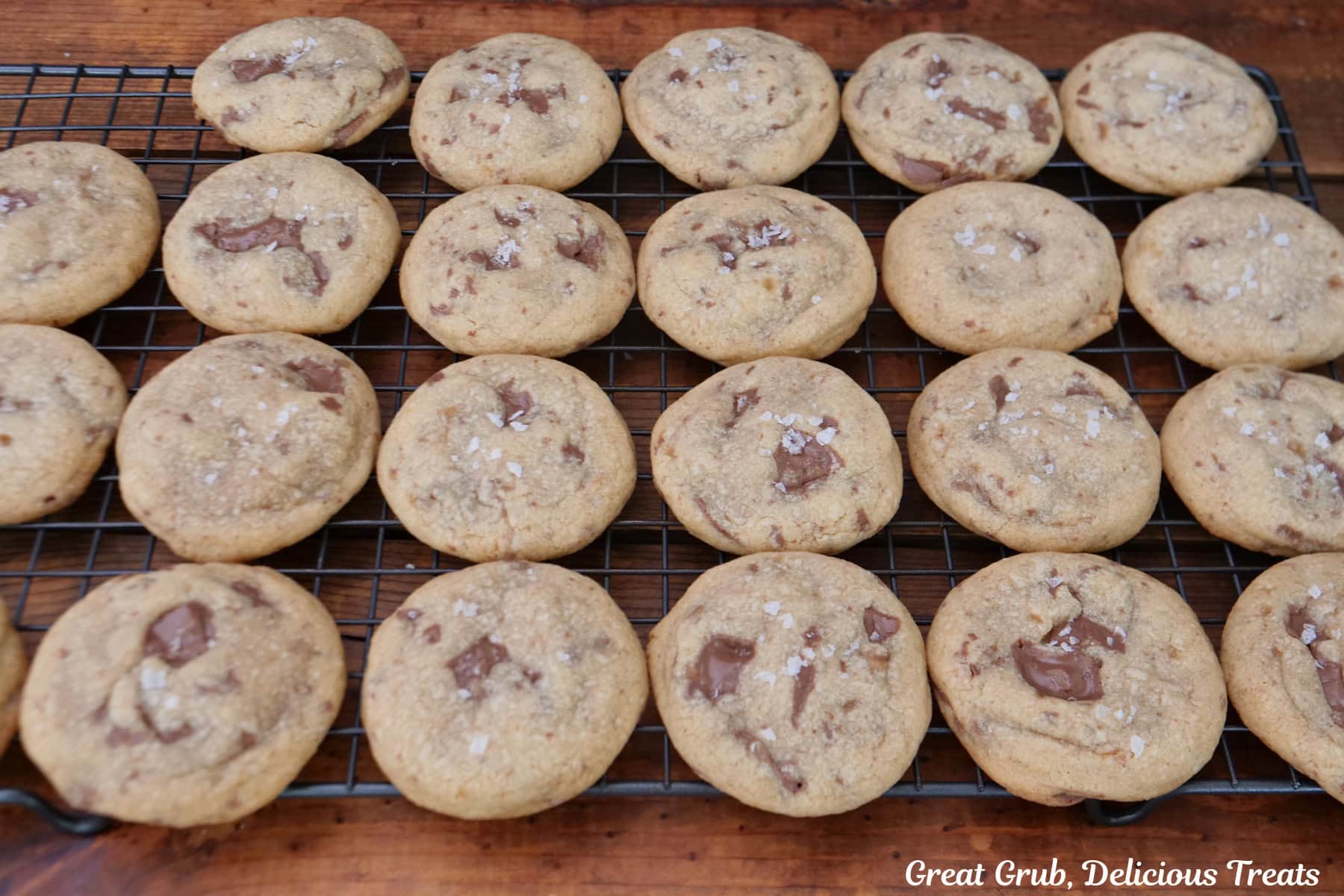 A wire rack with chocolate caramel cookies on it cooling.