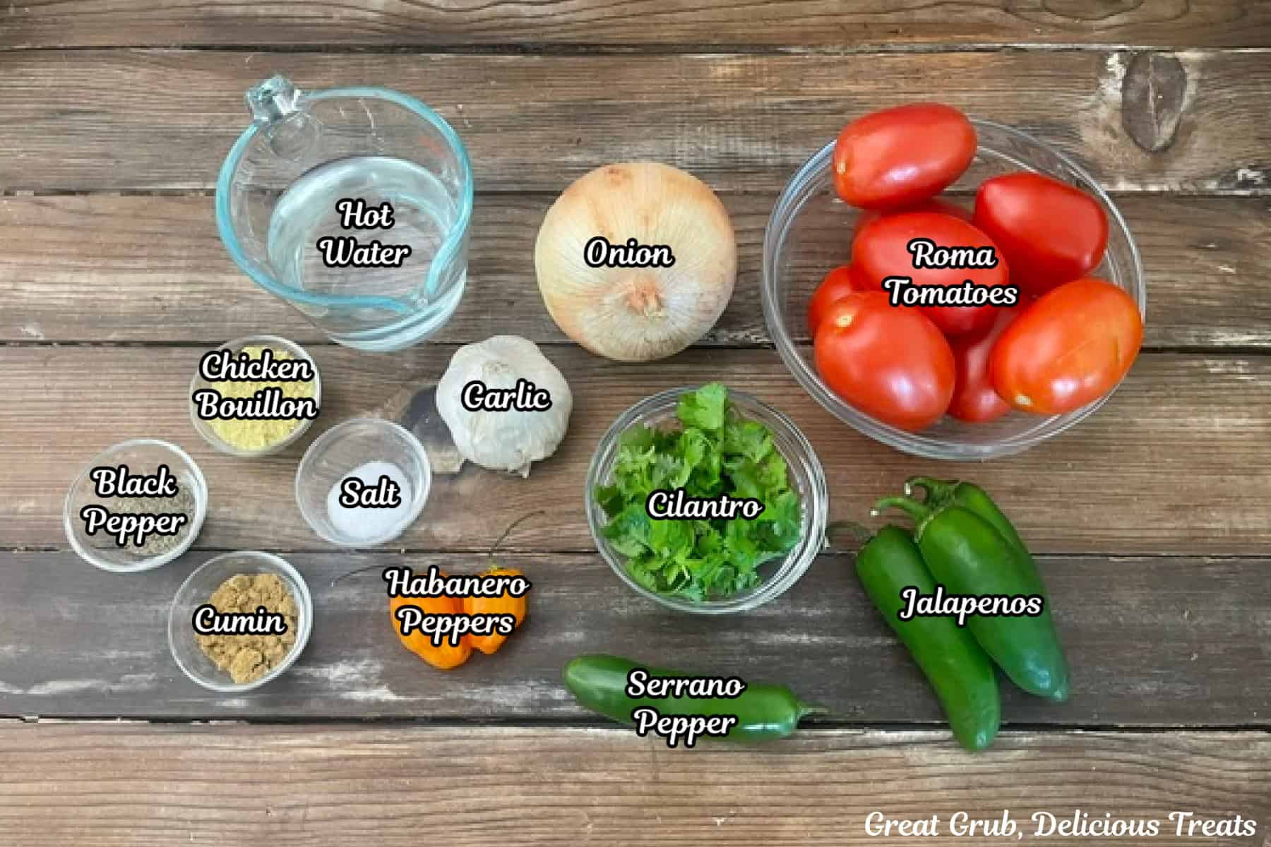 A wood surface with all the ingredients placed on it to make homemade habanero salsa.