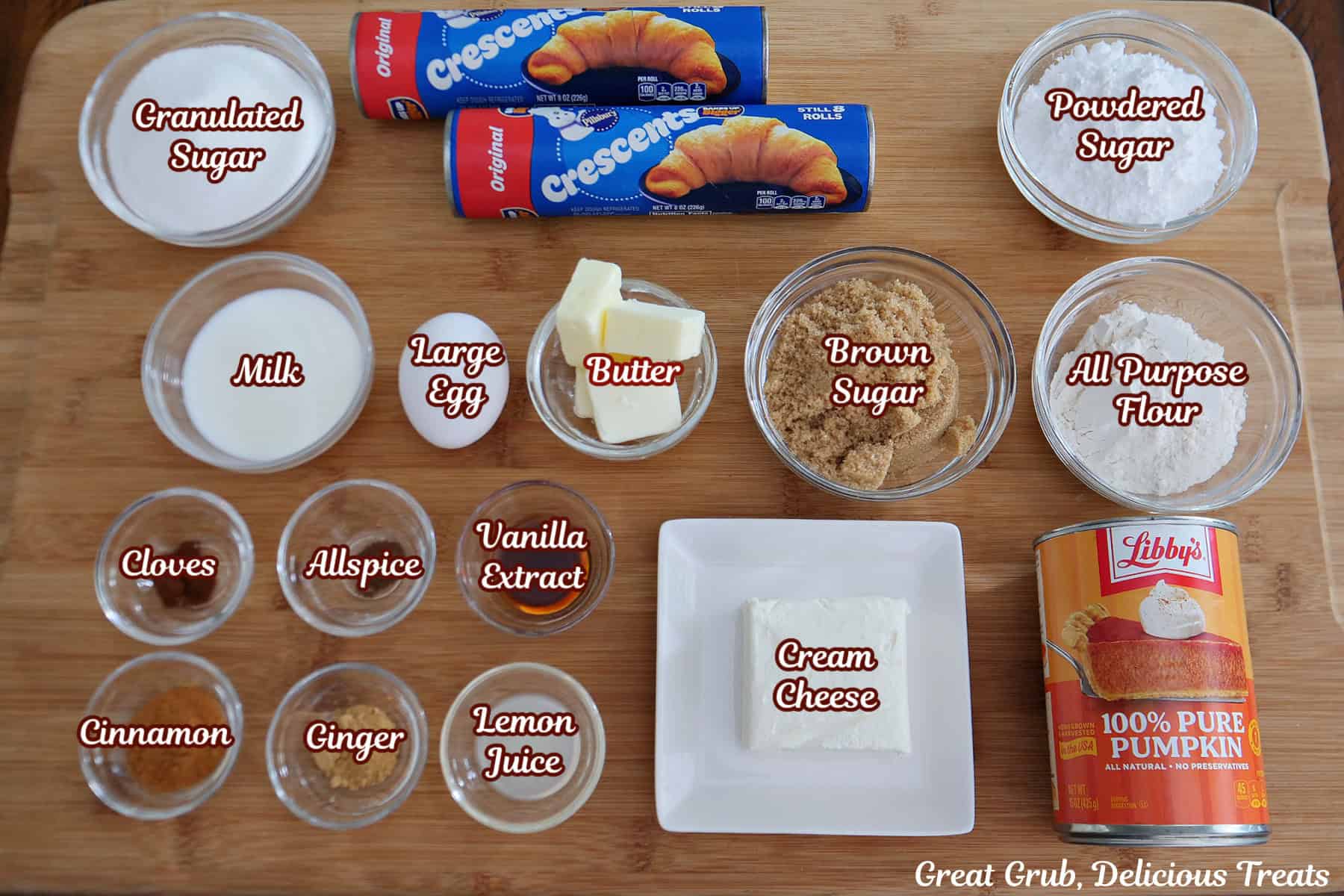 A wood surface with all the ingredients placed on it to make pumpkin cream cheese streusel twists.