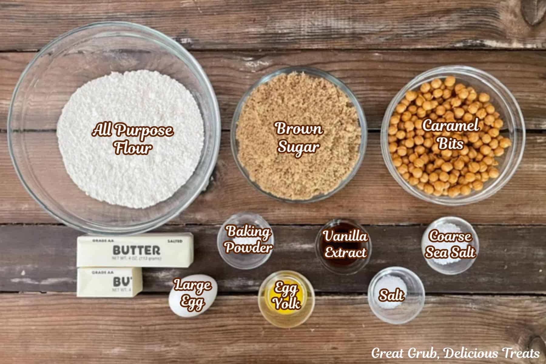 A wood surface with all the ingredients placed on it to make salted caramel blondies.