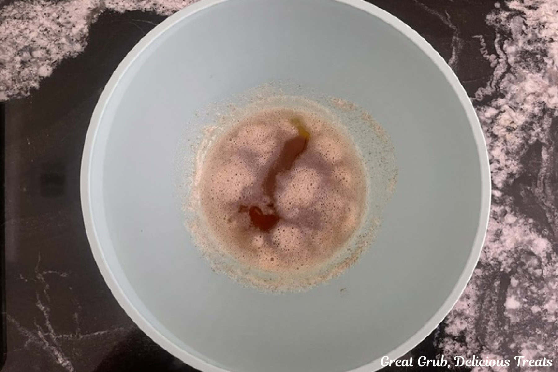 A mixing bowl with browned butter cooling in it.