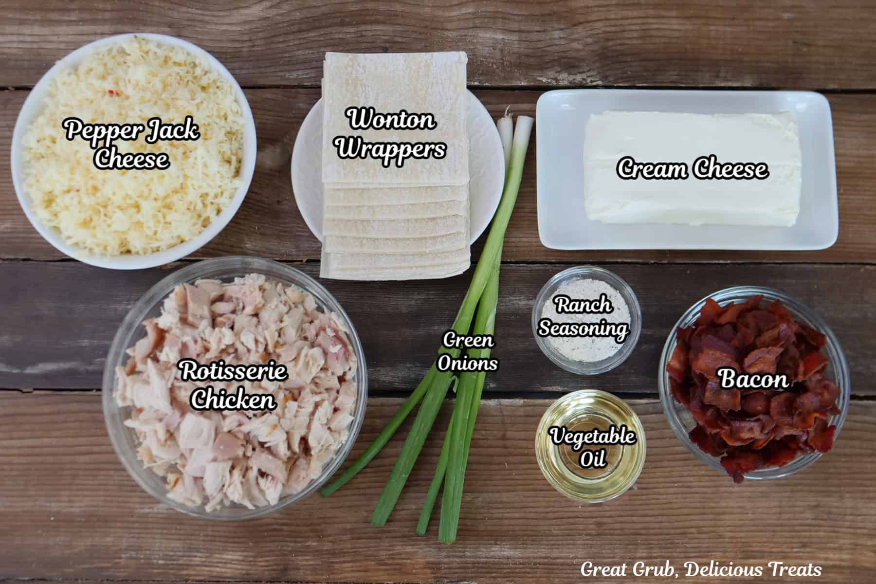 A wood surface with all the ingredients placed on it to make chicken bacon ranch wonton cups.