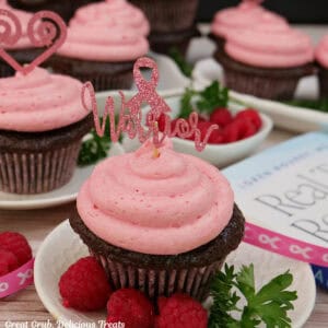 White plates with chocolate cupcakes with raspberry frosting on top with Dr. Rourke's Real Talk, Real Hope book in the background.