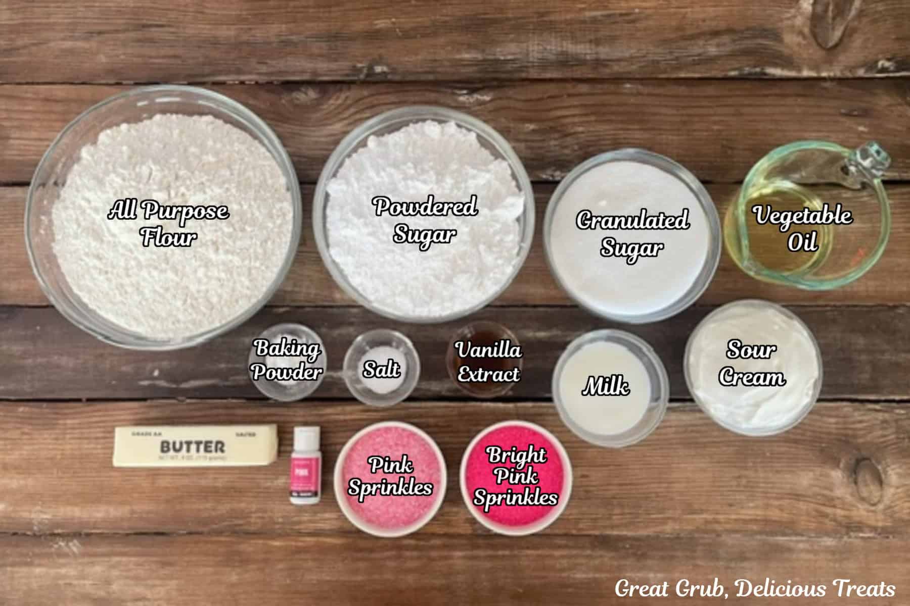 A rustic wood surface with all the ingredients placed on it to make frosted warrior sugar cookies with buttercream frosting.