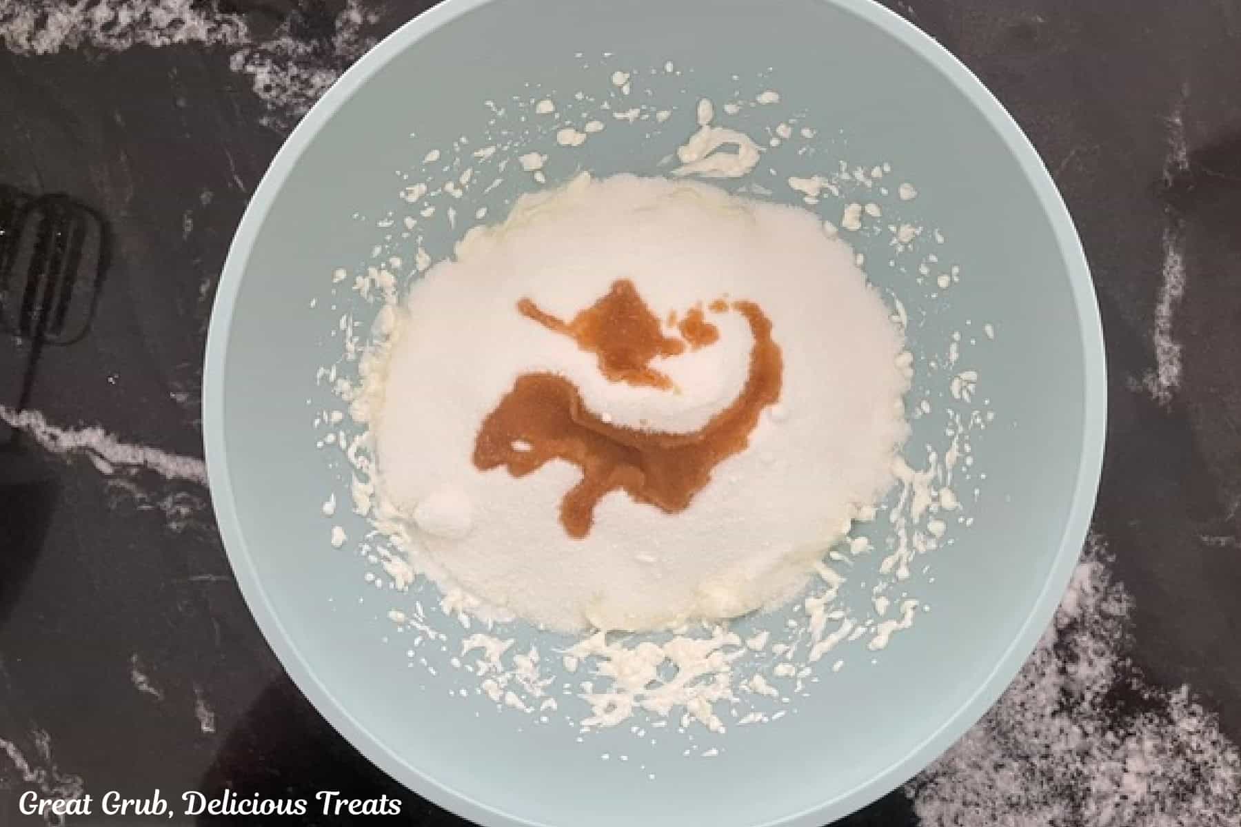 A light colored mixing bowl with the wet cookie ingredients in it before being combined together.
