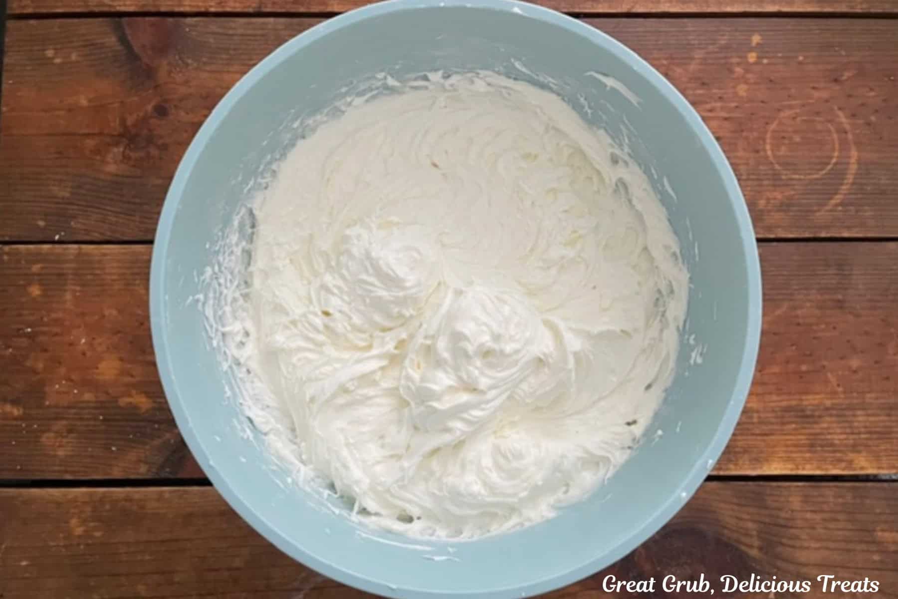 A light blue bowl with the maple frosting in it.