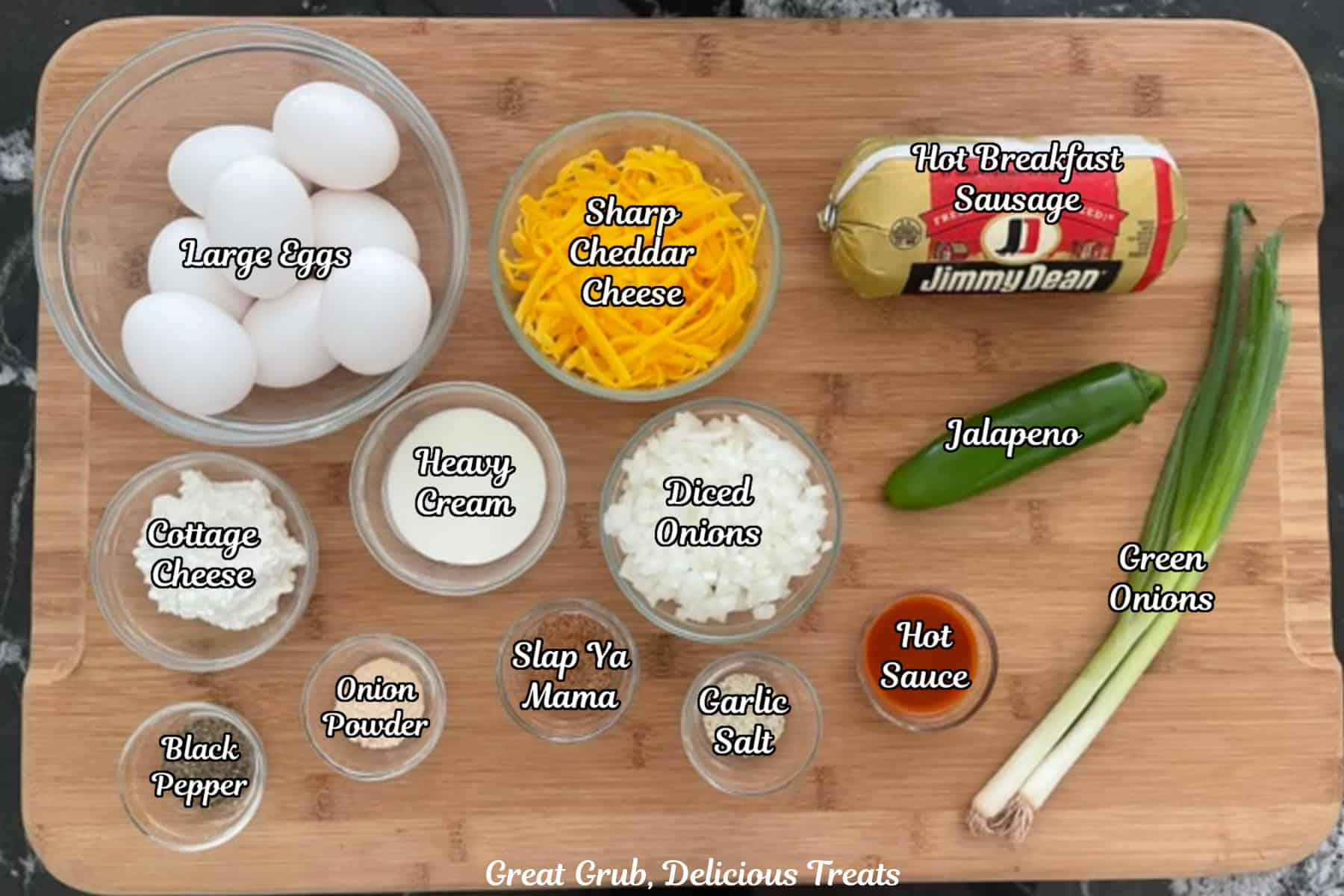 A wood cutting board with all the ingredients placed on it to make sausage egg bites.