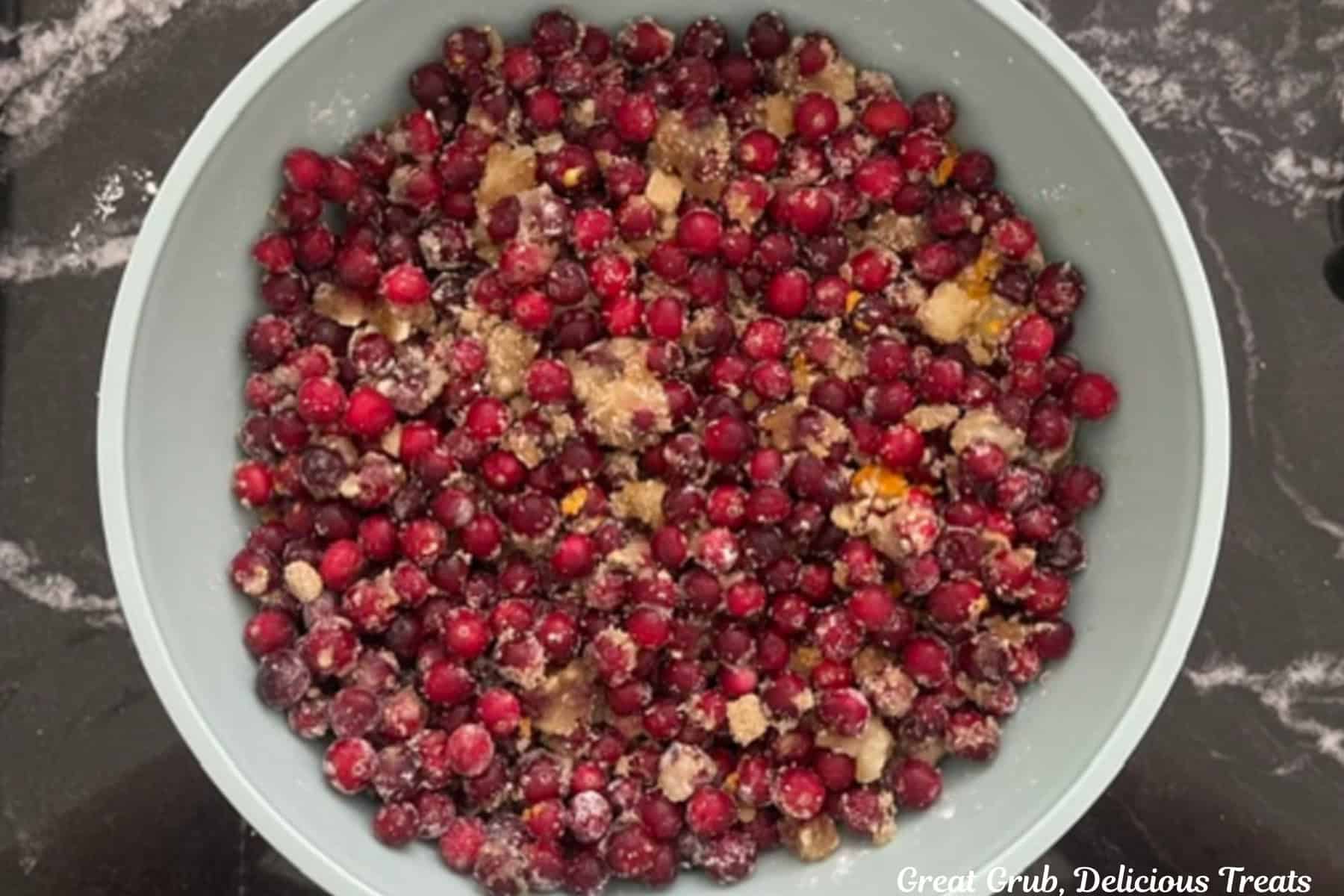 A white bowl with cranberry orange filling ingredients in it.
