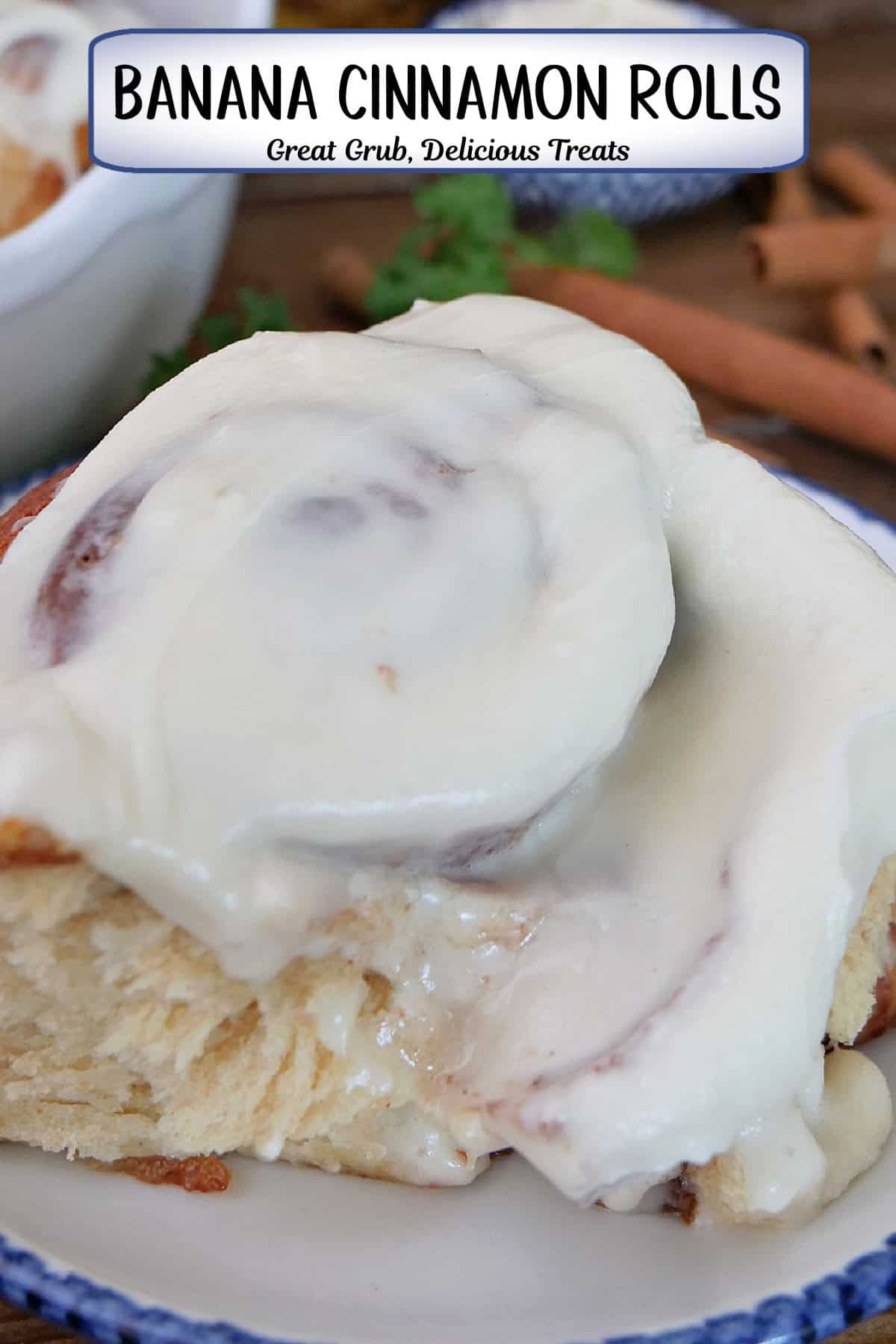  A white plate with blue trim and a homemade cinnamon rolls with cream cheese frosting on it, and a title overlay at the top.