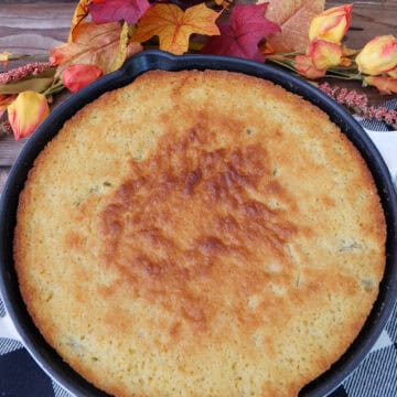 A black and white placemat with jalapeno cornbread in a round cast iron skillet, and a title overlay at the top.