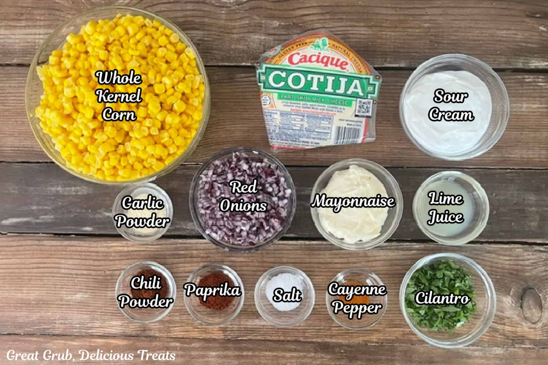 A rustic wood surface for all the ingredients placed on it to make street corn dip.